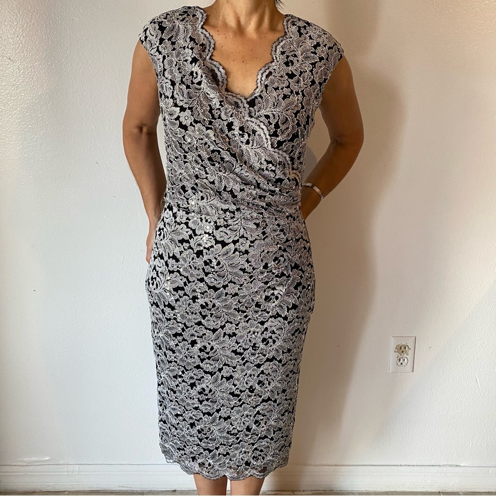 Silver and black dress with scalloped edging along neckline.